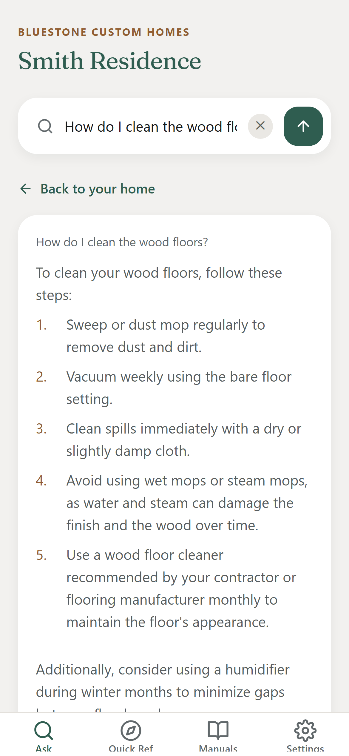The app after a question: the asked question repeated above the answer, then numbered steps for cleaning wood floors, drawn from the documents for that home.